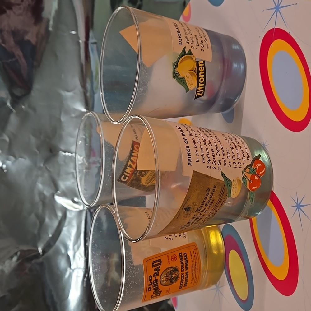 Vintage multi-colored lowball glasses with drink recipe labels